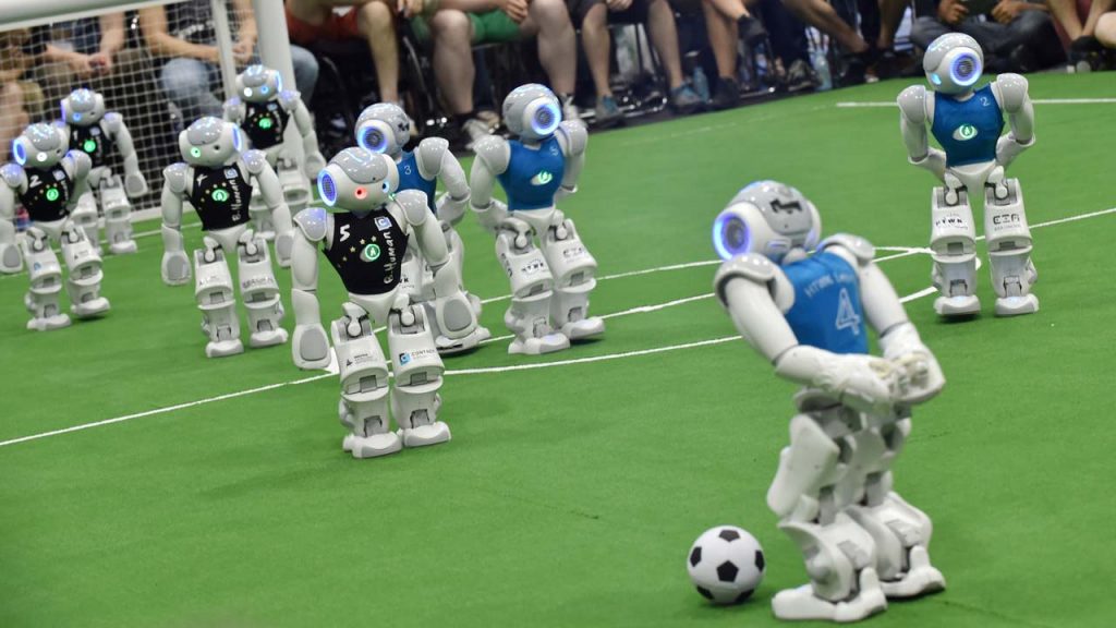 Robots fight for the ball during their football match in the standard platform league tournament at the RoboCup 2017 in Nagoya, Aichi prefecture on July 30, 2017